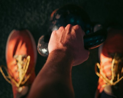 Detail of hands using light free weights with proper form